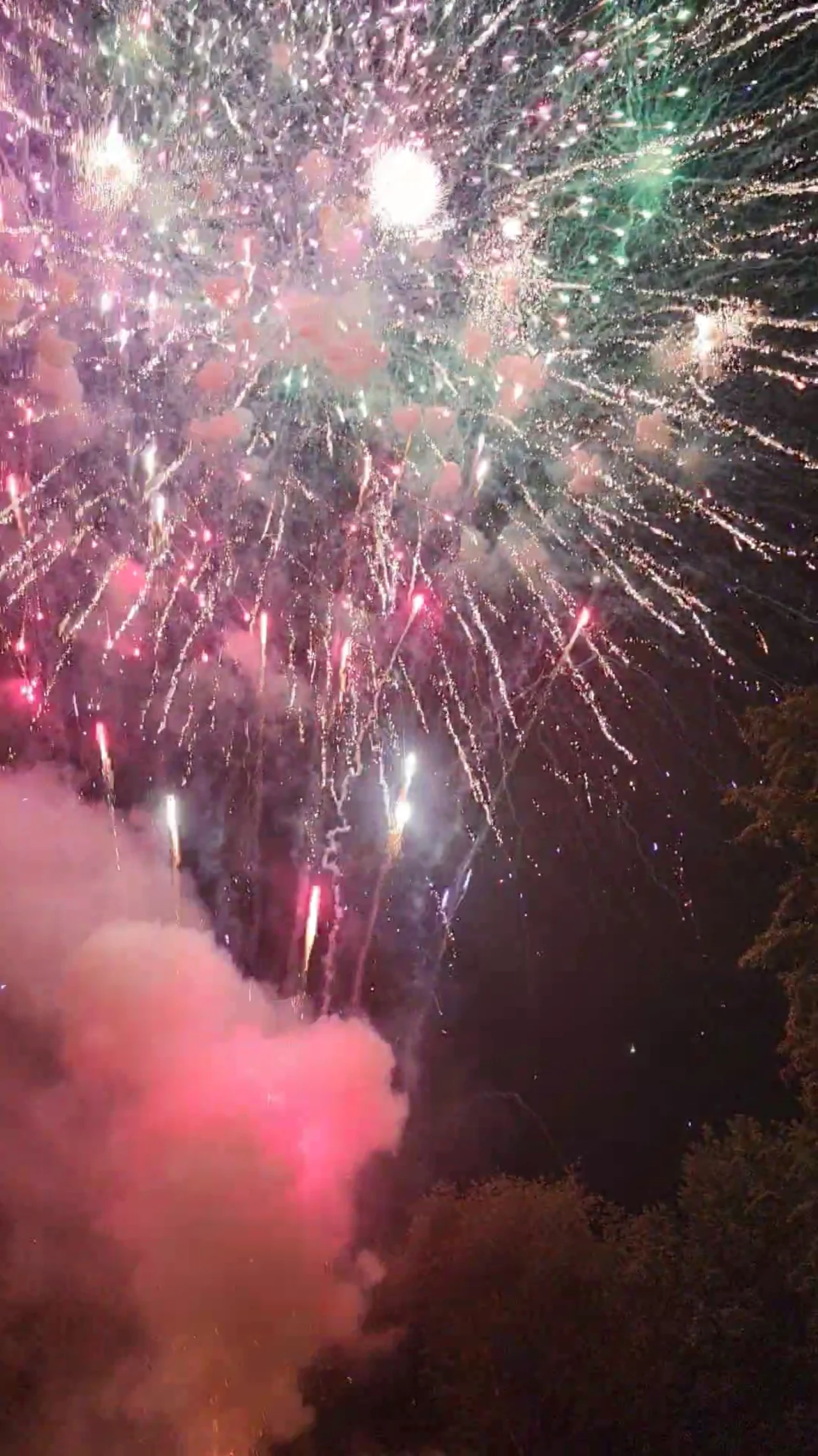 White and colored aerial fireworks filling the sky